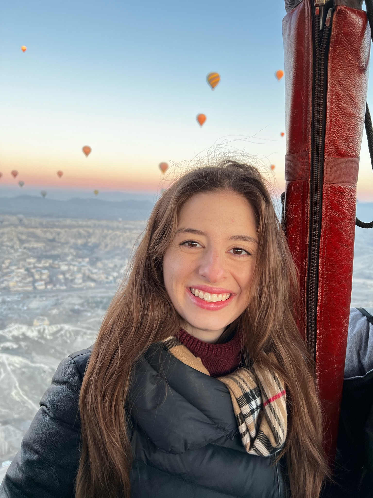 Emily Satel smiling on a sunrise hot air balloon ride